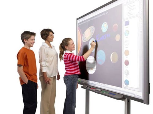 Students and teachers operating the interactive board
