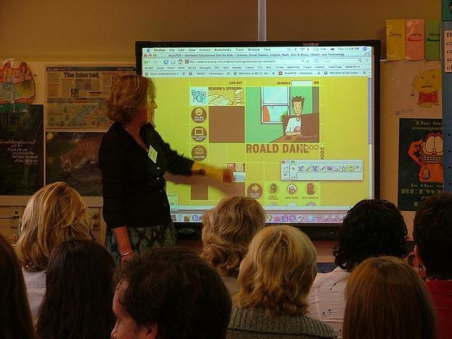 Teachers are receiving training in the operation of an interactive display